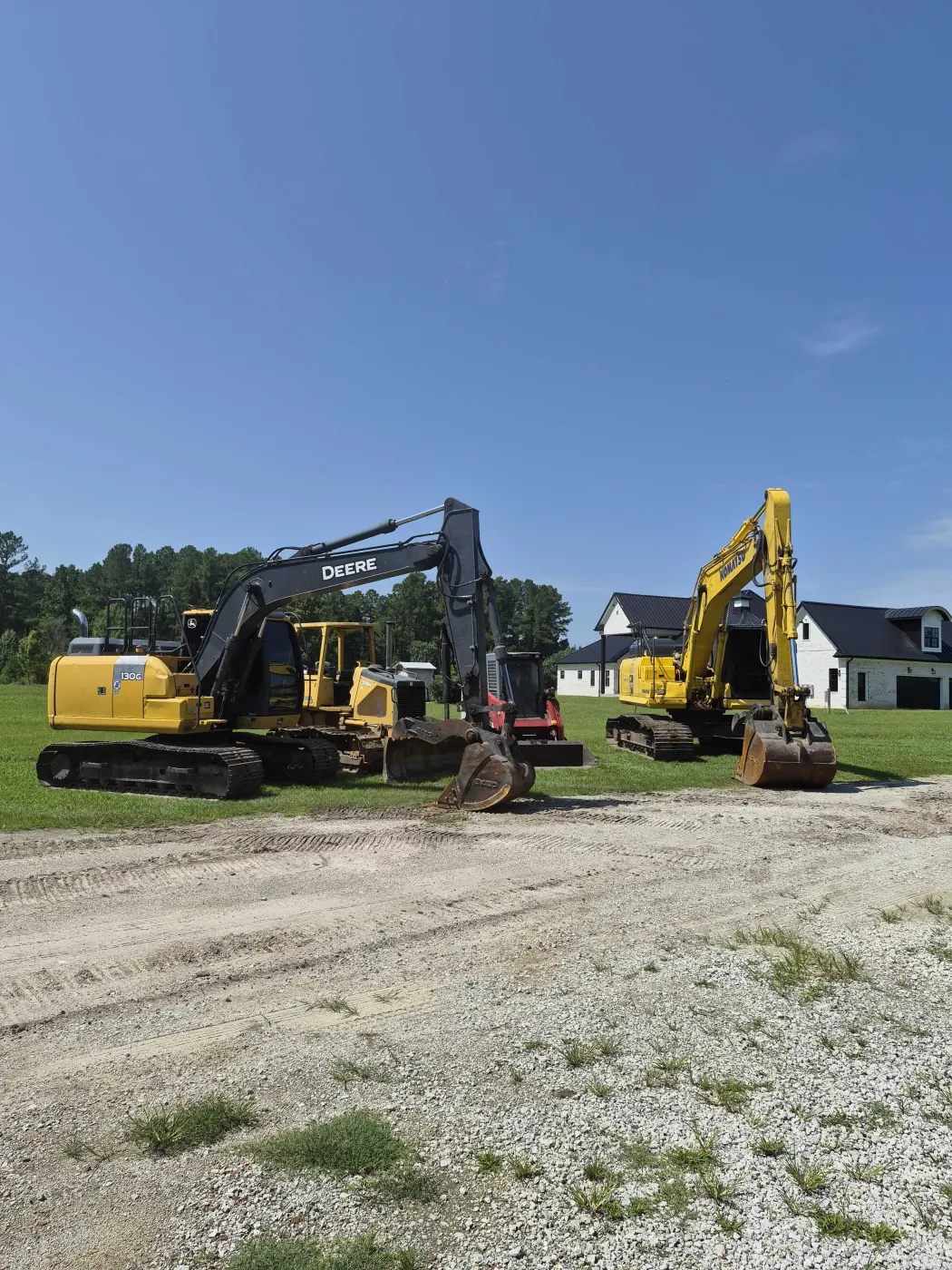 Excavator digging a building pad during site prep work in Burgaw, NC